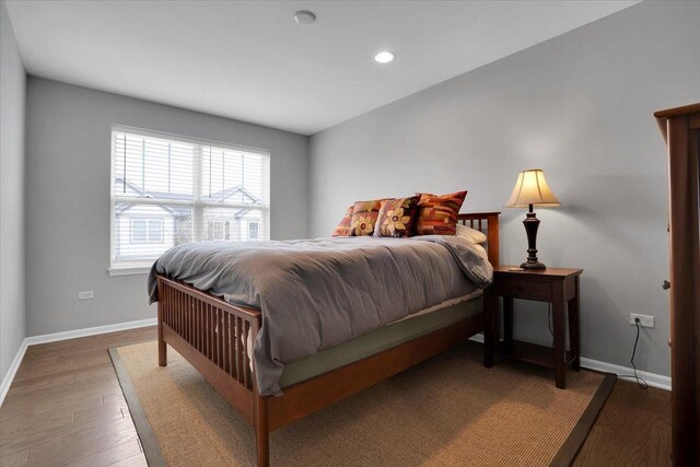 bedroom with wood finished floors, recessed lighting, and baseboards