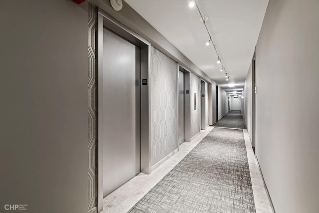 hallway with elevator and rail lighting