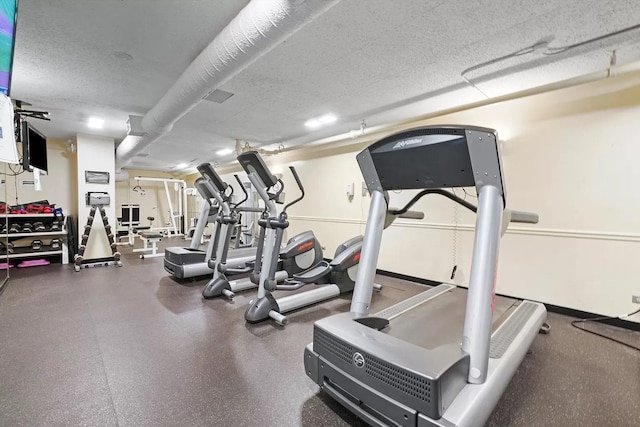workout area featuring a textured ceiling