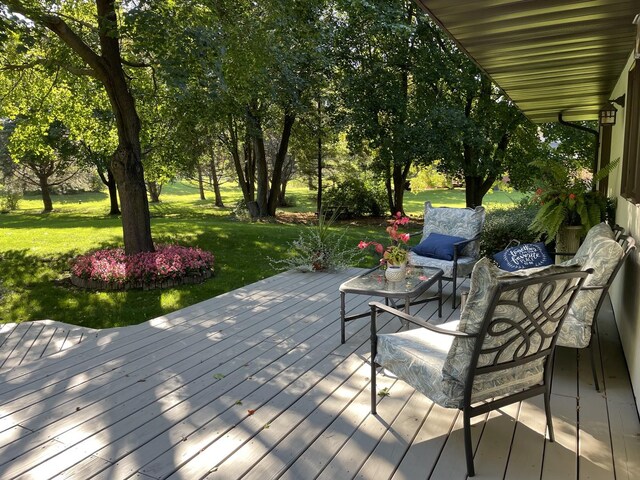 wooden terrace featuring a yard