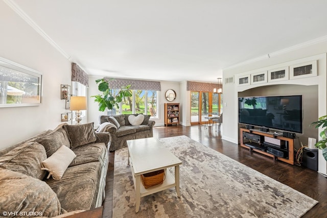 living area with crown molding, dark wood-style floors, and a notable chandelier