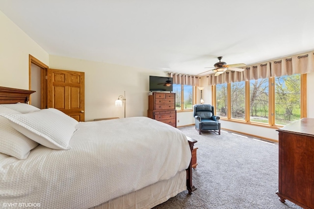 carpeted bedroom with baseboards and ceiling fan