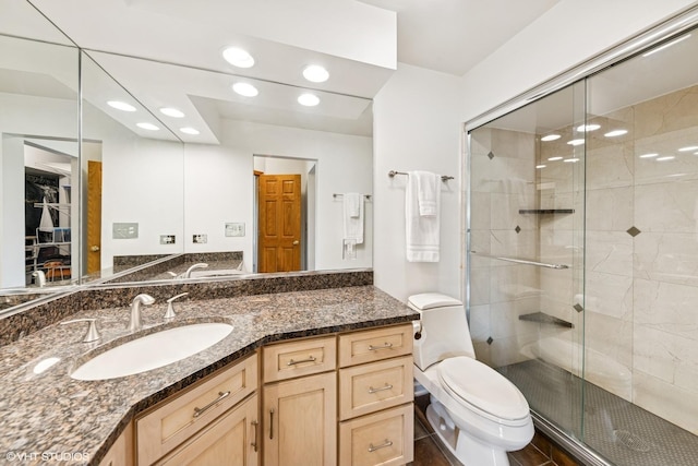 full bathroom with toilet, vanity, recessed lighting, and a stall shower