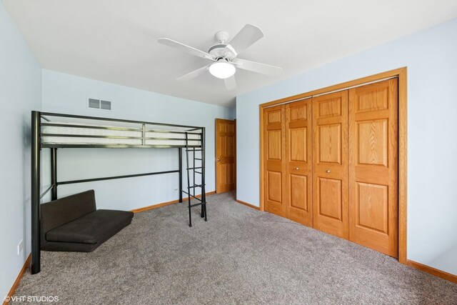 unfurnished bedroom with baseboards, visible vents, carpet floors, and a closet