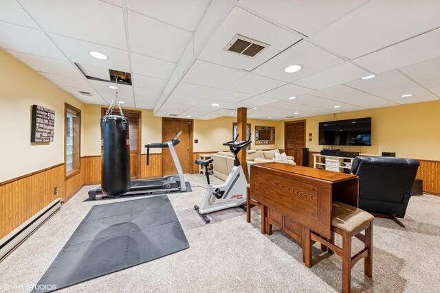 workout room with carpet, a wainscoted wall, wood walls, visible vents, and baseboard heating