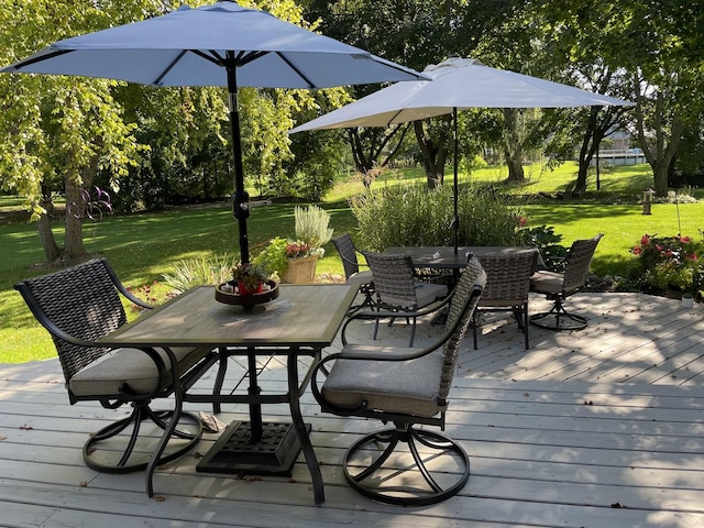 wooden terrace with a yard and outdoor dining space