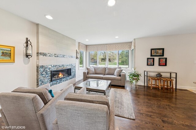 living room with baseboards, a tile fireplace, wood finished floors, and recessed lighting