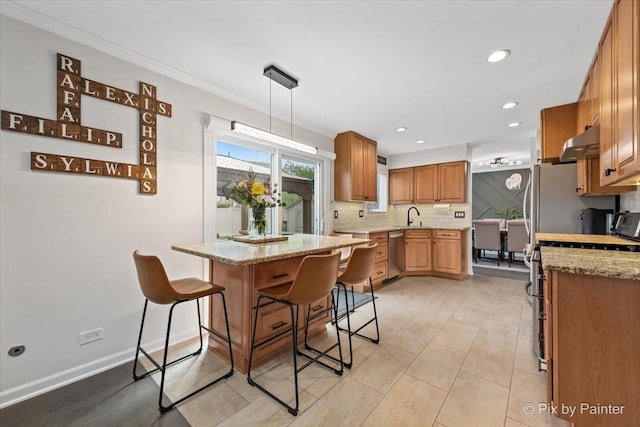 1682 Brompton Ln, Crystal Lake, IL 60014 - kitchen featuring a kitchen bar, under cabinet range hood, a sink, appliances with stainless steel finishes, and backsplash