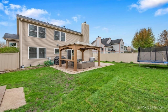 1682 Brompton Ln, Crystal Lake, IL 60014 - rear view of house with a trampoline, a patio area, a gazebo, a fenced backyard, and outdoor lounge area