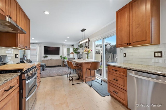 1682 Brompton Ln, Crystal Lake, IL 60014 - kitchen with appliances with stainless steel finishes, light stone counters, backsplash, open floor plan, and under cabinet range hood
