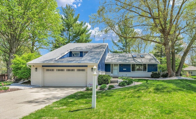view of front of property with an attached garage, driveway, and a front lawn
