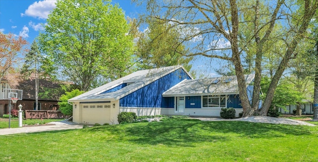 view of front of house with concrete driveway, a front yard, and a garage