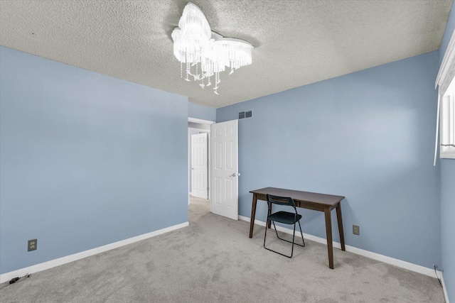 unfurnished bedroom with a chandelier, carpet, a textured ceiling, and baseboards