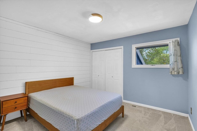 bedroom with a closet, baseboards, and carpet flooring