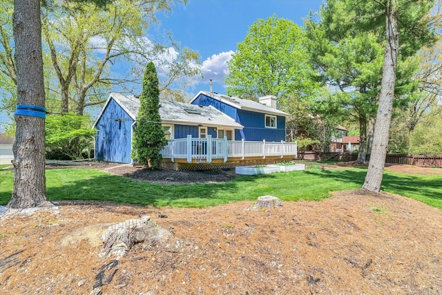 rear view of house with a deck and a chimney