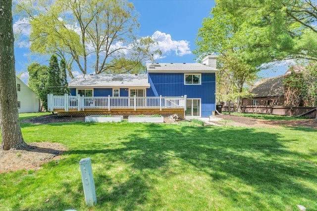 rear view of house featuring a wooden deck and a chimney