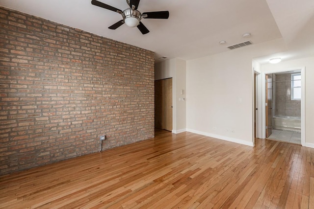 1334 W Estes Ave Unit 2S, Chicago, IL 60626 - empty room with light wood-type flooring, baseboards, visible vents, brick wall, and ceiling fan