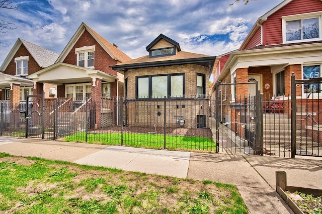 view of front of property featuring a gate, brick siding, a porch, and a fenced front yard