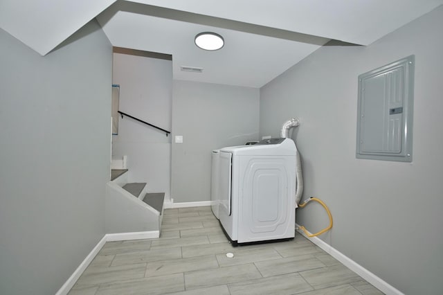 washroom featuring electric panel, washer / dryer, laundry area, baseboards, and visible vents