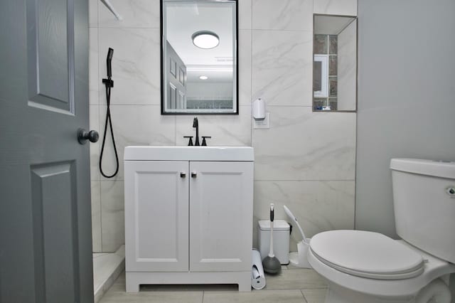 full bath featuring tile walls, toilet, and vanity
