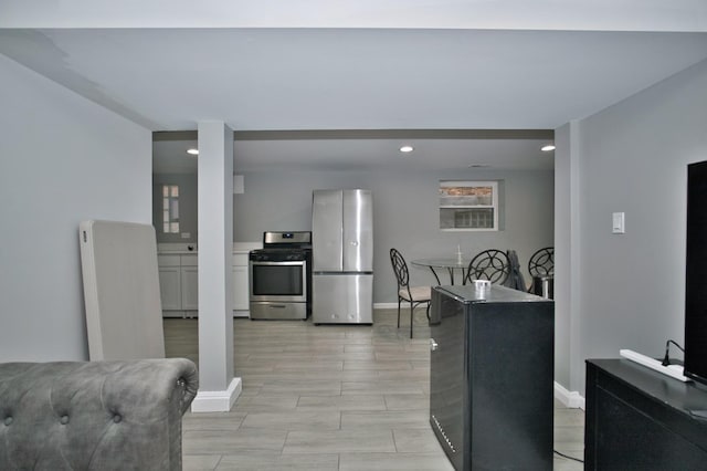 kitchen featuring baseboards, recessed lighting, and appliances with stainless steel finishes