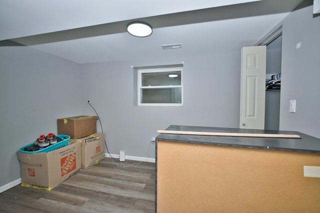 interior space featuring visible vents, baseboards, and dark wood finished floors