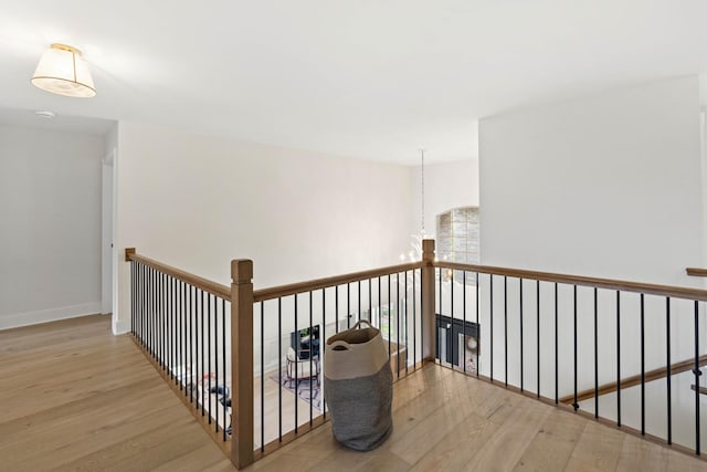 hall with wood finished floors and baseboards