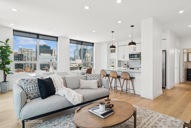 421 W Huron St Unit 1504, Chicago, IL 60654 - living room featuring light wood-type flooring, a skyline view, and recessed lighting