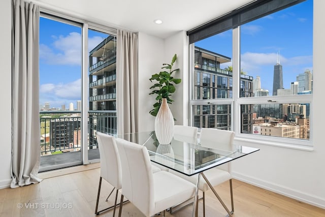 421 W Huron St Unit 1504, Chicago, IL 60654 - dining space featuring a wall of windows, a view of skyline, plenty of natural light, wood finished floors, and recessed lighting