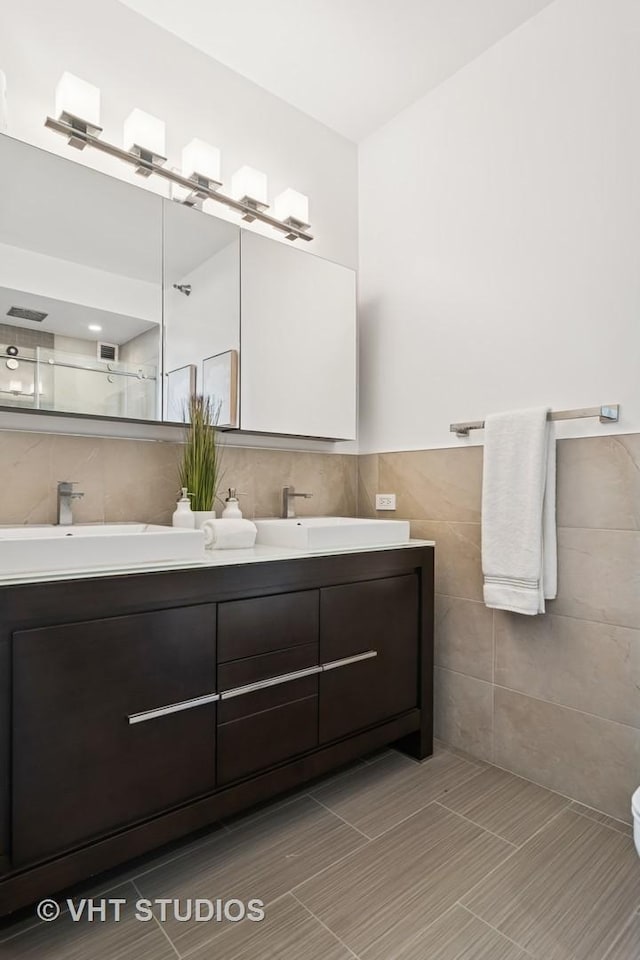 421 W Huron St Unit 1504, Chicago, IL 60654 - bathroom featuring tile walls, double vanity, and a shower