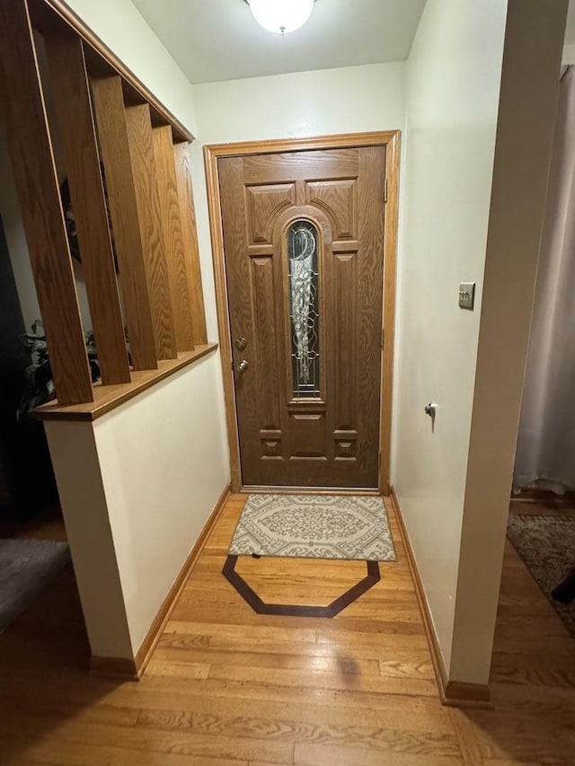 entryway featuring light wood-style flooring and baseboards