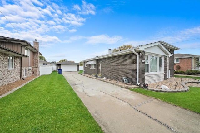 view of home's exterior with brick siding, a detached garage, a lawn, and fence