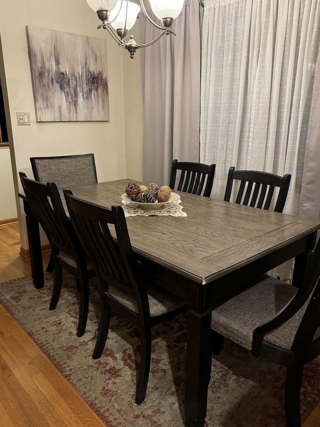 dining room with a chandelier and wood finished floors