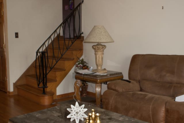 staircase with baseboards, wood finished floors, and a chandelier