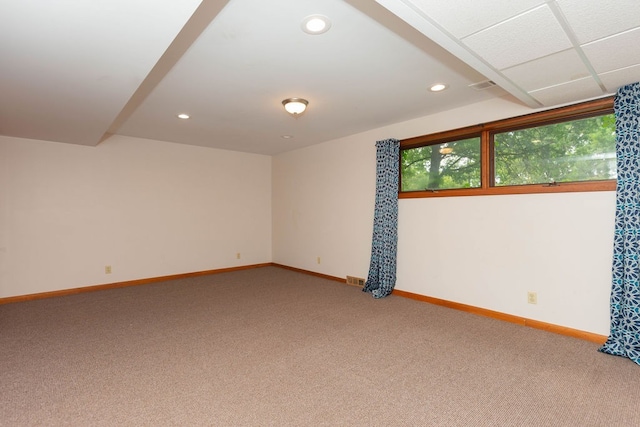 carpeted empty room with visible vents, baseboards, and recessed lighting