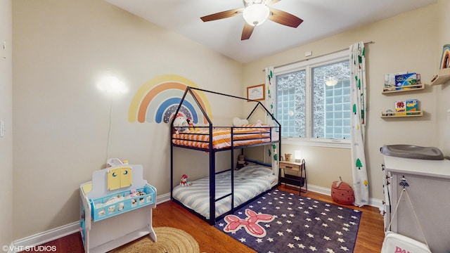 bedroom with baseboards, a ceiling fan, and wood finished floors