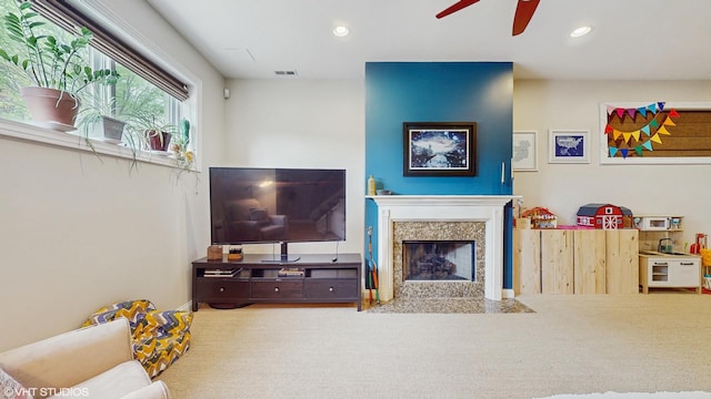 living room featuring a fireplace, a ceiling fan, recessed lighting, and visible vents