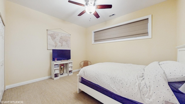 carpeted bedroom featuring a ceiling fan, baseboards, and visible vents