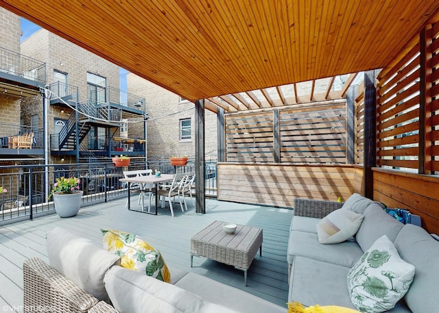 wooden terrace with outdoor dining area and an outdoor hangout area