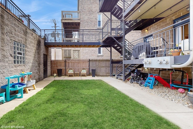 view of yard featuring stairway and fence