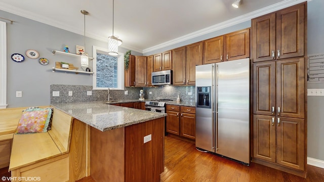 kitchen with a peninsula, light stone countertops, dark wood-type flooring, backsplash, and stainless steel appliances