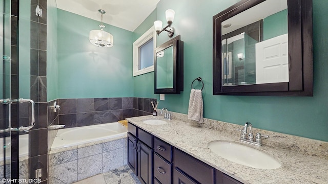 bathroom featuring double vanity, a tile shower, a sink, and a garden tub