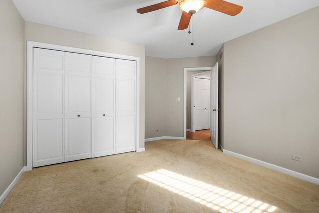 4240 Kingshill Cir, Naperville, IL 60564 - unfurnished bedroom featuring light carpet, a closet, and a ceiling fan