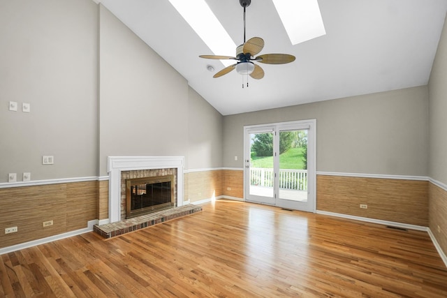 4240 Kingshill Cir, Naperville, IL 60564 - unfurnished living room with wood finished floors, high vaulted ceiling, a skylight, a fireplace, and ceiling fan