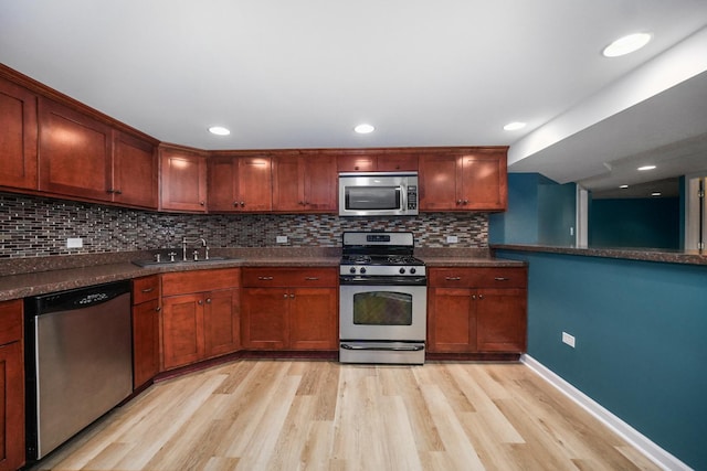 4240 Kingshill Cir, Naperville, IL 60564 - kitchen featuring appliances with stainless steel finishes, light wood finished floors, backsplash, dark countertops, and recessed lighting