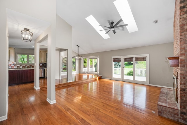 4240 Kingshill Cir, Naperville, IL 60564 - unfurnished living room featuring plenty of natural light, wood finished floors, high vaulted ceiling, and a chandelier
