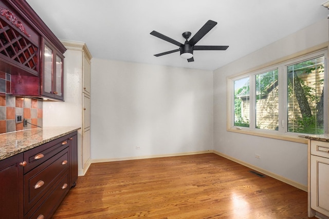 4240 Kingshill Cir, Naperville, IL 60564 - kitchen with a ceiling fan, light wood-type flooring, tasteful backsplash, and light stone countertops