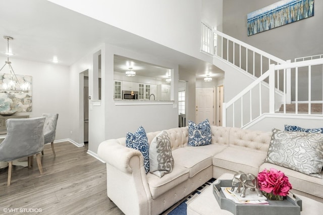 214 Woodstone Dr, Buffalo Grove, IL 60089 - living room with baseboards, stairs, wood finished floors, and a notable chandelier