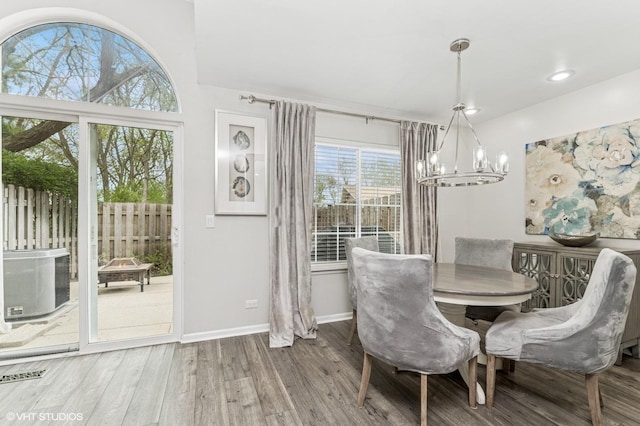 214 Woodstone Dr, Buffalo Grove, IL 60089 - dining space featuring visible vents, wood finished floors, baseboards, recessed lighting, and a notable chandelier