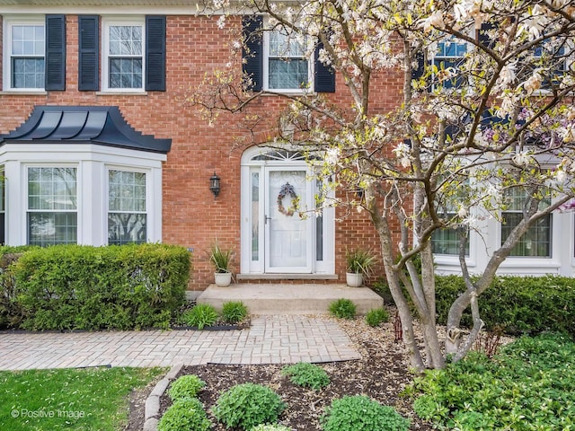 property entrance featuring brick siding